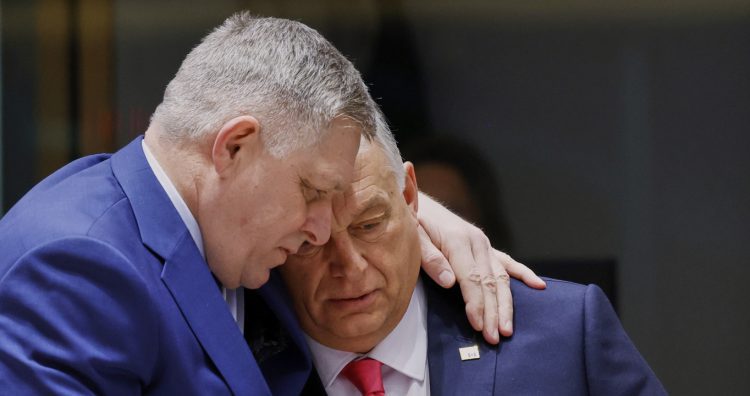 Slovakia's Prime Minister Robert Fico, left, speaks with Hungary's Prime Minister Viktor Orban during a round table meeting at an EU summit in Brussels, Thursday, March 20, 2025. (AP Photo/Omar Havana)