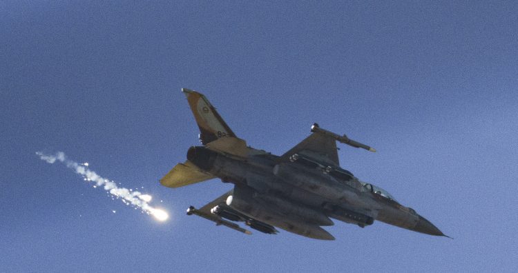 An Israeli fighter jet releases flares as it flies over the Gaza Strip, as seen from southern Israel, Saturday, Dec. 9, 2023. (AP Photo/Leo Correa)