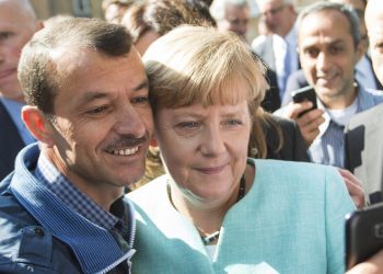 FILE - German Chancellor Angela Merkel taking a selfie with a refugee at the refugee reception center in Berlin, Germany, Sept. 10, 2015. Merkel became the face of a welcoming approach to migrants as people fleeing conflicts in Syria and elsewhere trekked across the Balkans. More than 1 million asylum-seekers entered Germany in 2015-16. (Bernd von Jutrczenka/dpa via AP, File)