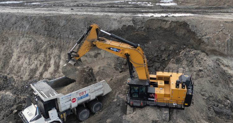 An excavator loads an autonomous mining truck in the Huaneng Yimin open-pit coal mine in Hulunbuir in northern China's Inner Mongolia province China, Monday, Sept. 15, 2025. (AP Photo/Ng Han Guan)