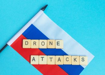The National Flag of The Russian Federation, along with a sign reading Drone Attacks,Image: 981863535, License: Royalty-free, Restrictions: , Model Release: yes, Credit line: - / DPphoto / Profimedia
